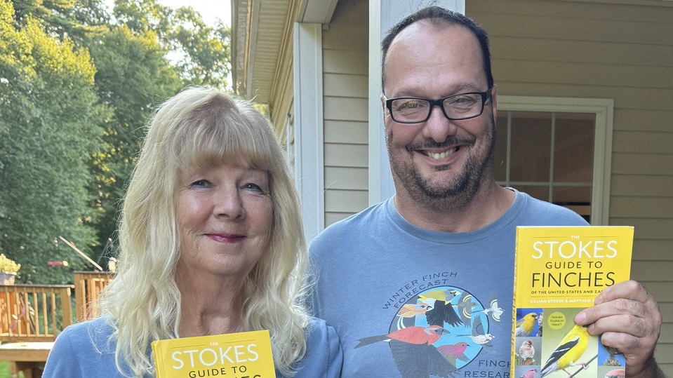 Photo of November 2025 speaker Matthew Young with Lillian Stokes showing off their new guide to finches.